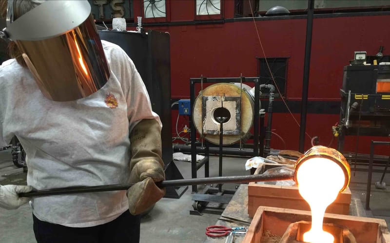 Hot glass sand casting process in the studio